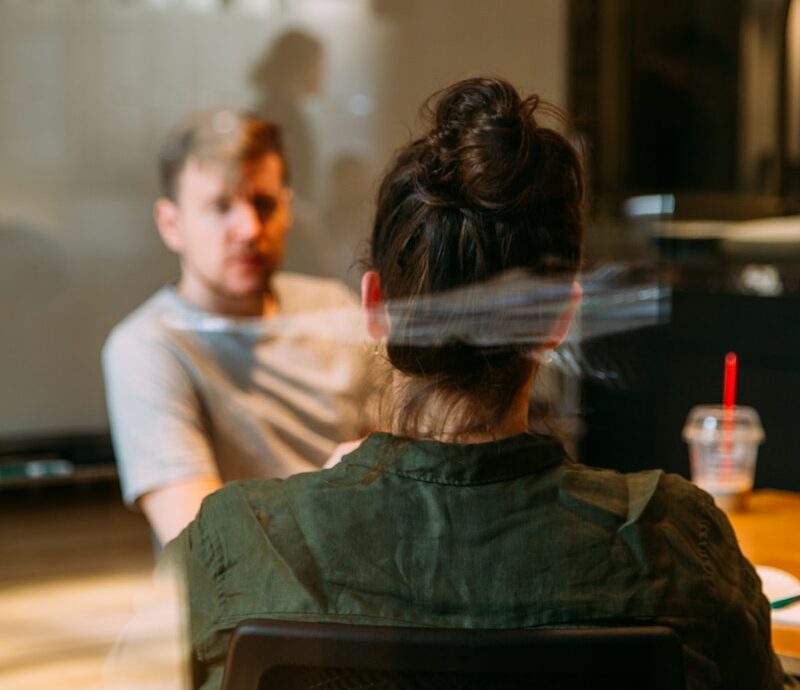 person sitting in a chair in front of a man